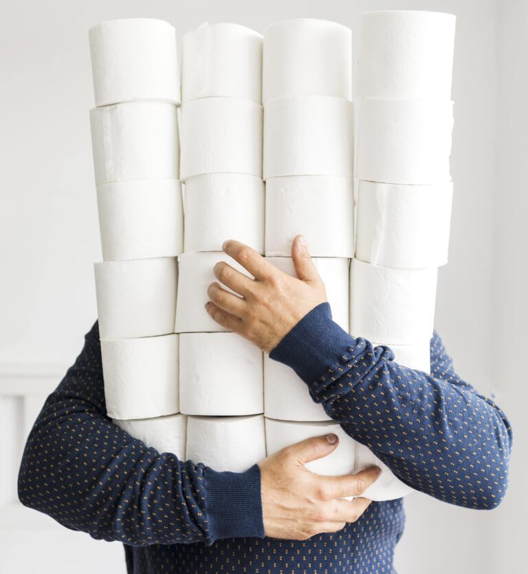 man with stack toilet paper min 768x834