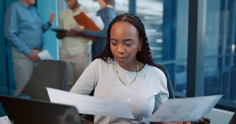 office laptop woman with paperwork planning accountant financial report graphs audit employee business review with documents investment revenue project management 1 768x405