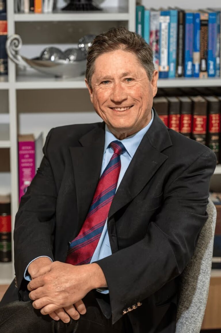Stephen Thomson at desk smiling 768x1155